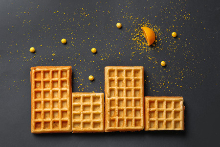 Creative composition with waffles on black backgroundの写真素材