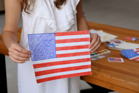 Woman holding drawing of American national flag, closeupの写真素材