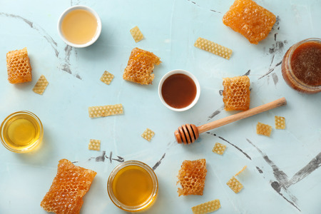 Composition with honey and combs on color table