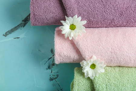 Rolled clean towels on color background, top viewの写真素材
