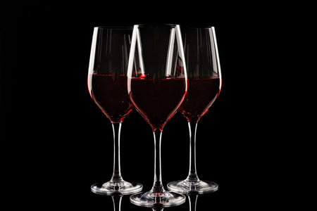 Glasses of red wine on dark backgroundの写真素材