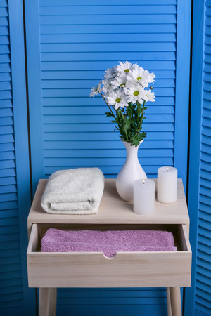 Clean soft towels in drawer and on table near folding screenの写真素材