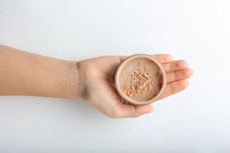 Woman holding powder on white backgroundの写真素材