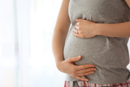 Beautiful pregnant woman at homeの写真素材