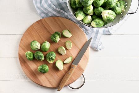 Wooden board with fresh brussels sprouts on table, top viewの写真素材
