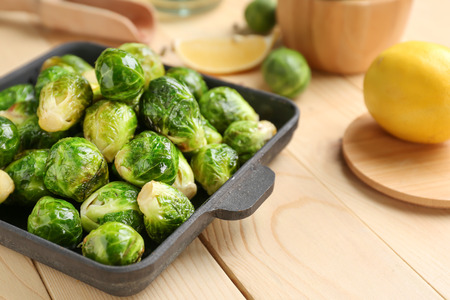Pan with delicious roasted Brussels sprouts on wooden table, closeupの写真素材