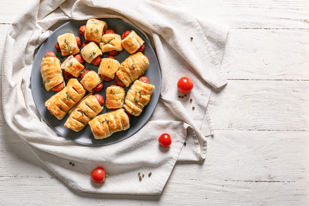 Delicious sausage rolls on wooden tableの写真素材