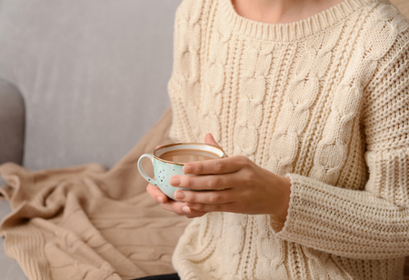 Woman holding cup of aromatic coffee, closeupの写真素材