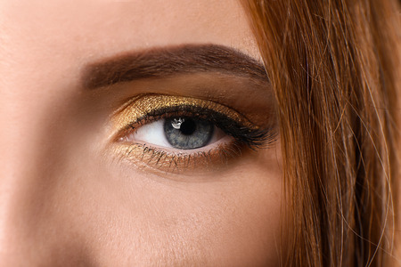 Beautiful woman with golden make up, closeupの写真素材