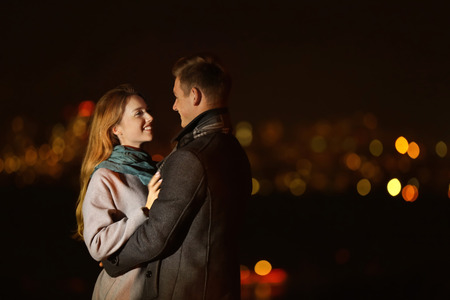 Loving young couple on romantic date at night