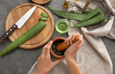 Woman making organic cosmetics with aloe. Health care conceptの写真素材
