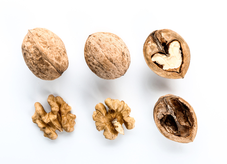 Tasty walnuts with shell on white background