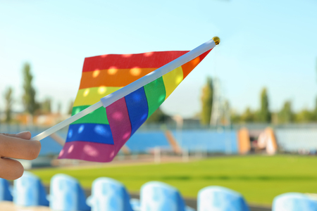 Woman holding rainbow LGBT flag outdoorsの写真素材