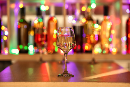 Glass of tasty wine on bar counterの写真素材