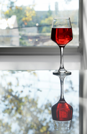 Glass of tasty wine on tableの写真素材