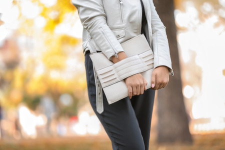 Fashionable young woman with stylish bag outdoorsの写真素材