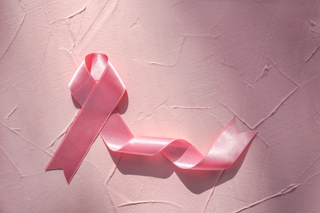 Pink ribbon on color table. Breast cancer conceptの写真素材