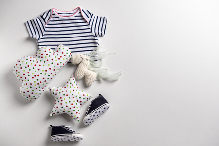 Cute baby clothes and toys on white backgroundの写真素材