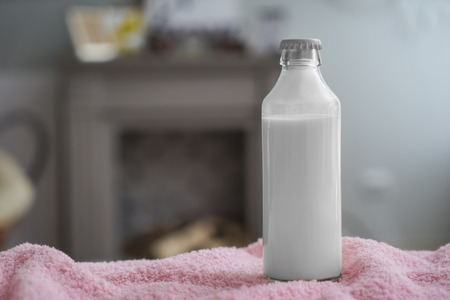 Bottle of milk on color cloth indoorsの写真素材
