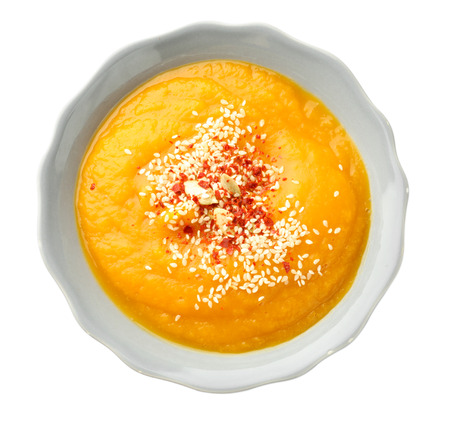 Plate with tasty pumpkin cream soup on white backgroundの写真素材