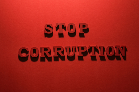 Text STOP CORRUPTION on red background