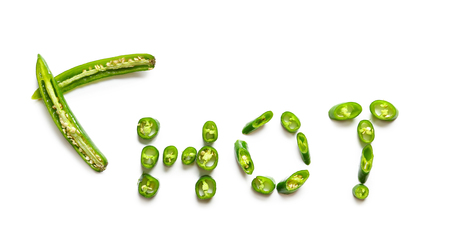 Word HOT made of sliced chili pepper on white backgroundの写真素材