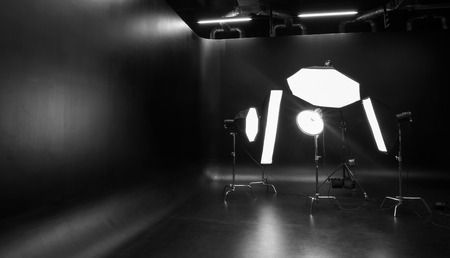 Interior of modern photo studio with professional lighting equipment
