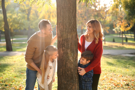 Happy family in autumn parkの写真素材