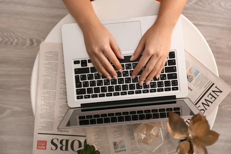 Woman using laptop on tableの写真素材
