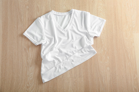 White female t-shirt on wooden backgroundの写真素材