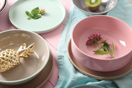 Tableware, flowers and decorations on pink wooden backgroundの写真素材