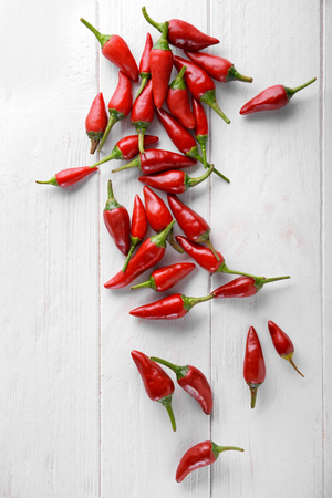 Fresh chili peppers on white wooden backgroundの写真素材