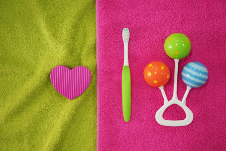 Toothbrush with rattle on soft towel