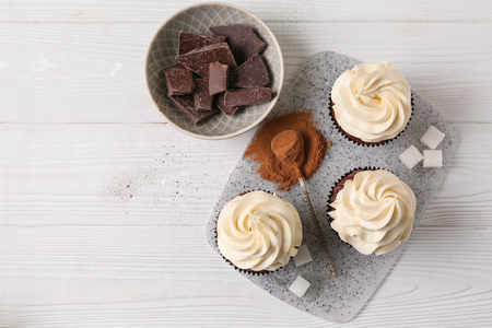 Tasty chocolate cupcakes on white tableの写真素材