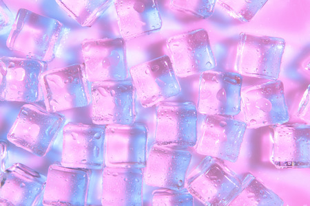 Ice cubes on color backgroundの写真素材