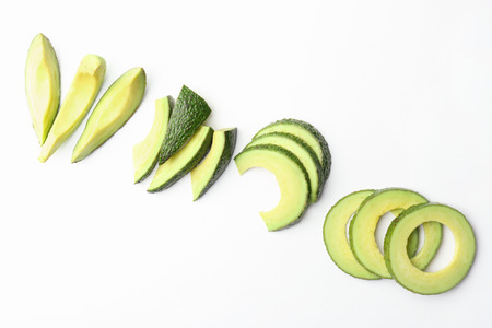 Composition with cut avocado on white background