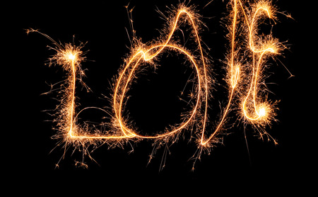 Sparklers forming word LOVE on dark backgroundの写真素材