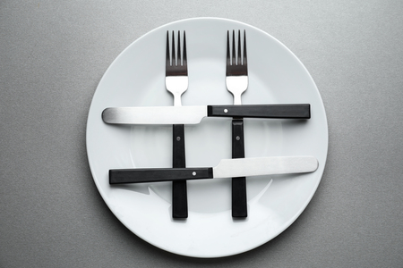 Plate with hashtag sign made of forks and knives on grey backgroundの写真素材