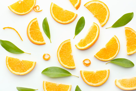 Slices of tasty ripe orange on white background