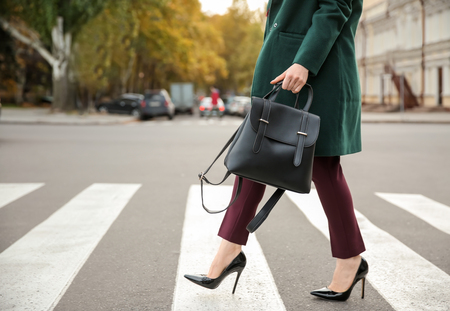 Beautiful fashionable woman crossing roadの写真素材