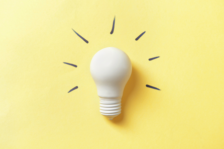Light bulb on color backgroundの写真素材