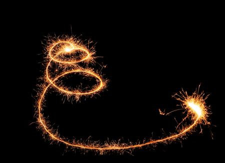 Shining spiral made of sparklers on dark backgroundの写真素材