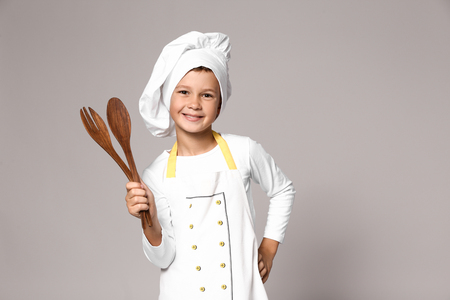Cute little chef on grey backgroundの写真素材