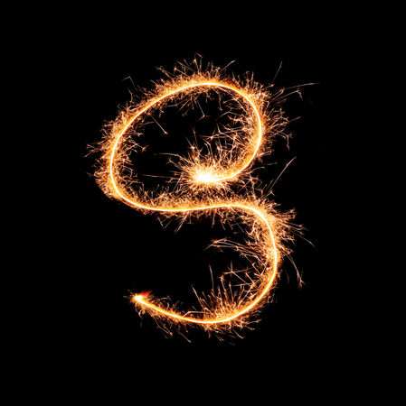 Sparklers forming letter S on dark backgroundの写真素材