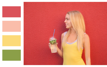 Beautiful young woman with fresh cocktail on color background. Different color patternsの写真素材