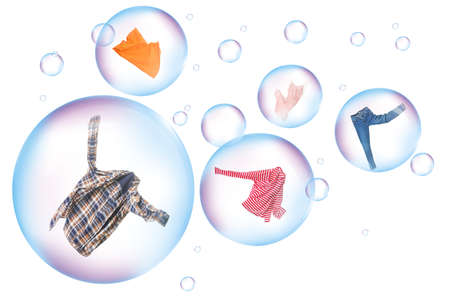 Soap bubbles with clean washed clothes on white background