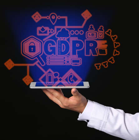 Male doctor with tablet computer and hologram projection of data protection service on dark...