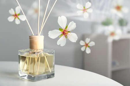 Floral reed diffuser on table in room