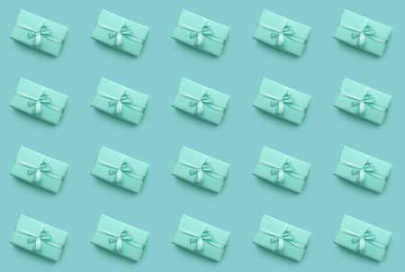 Many turquoise gift boxes on color background