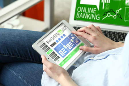 Woman using tablet computer for online banking at homeの写真素材